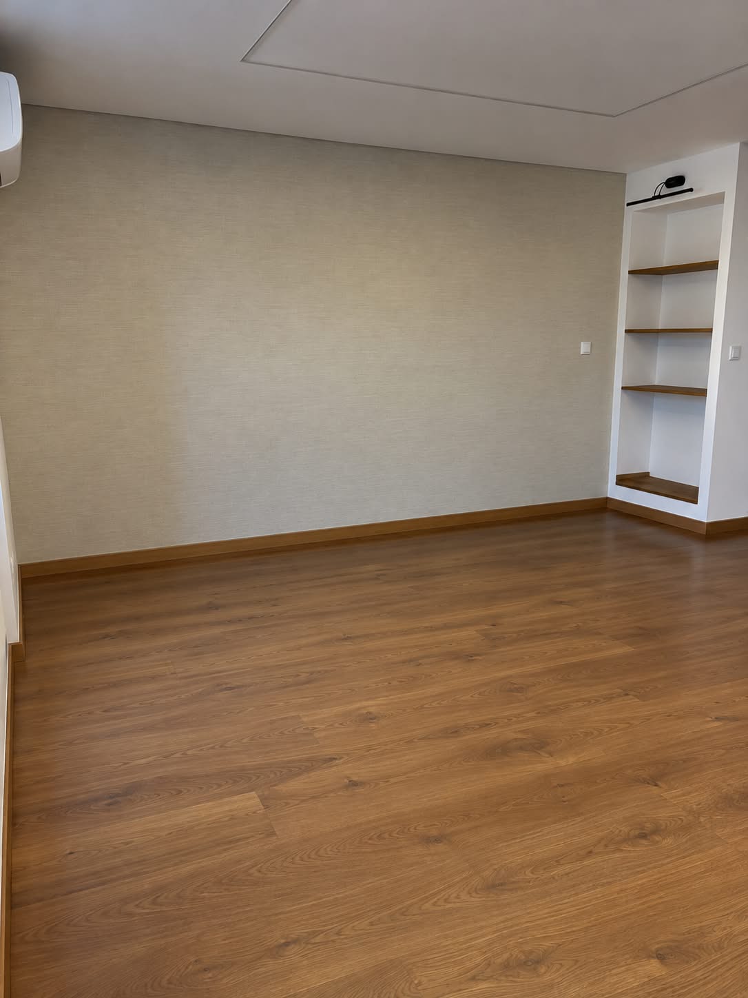 Sala com estante embutida e iluminação no teto